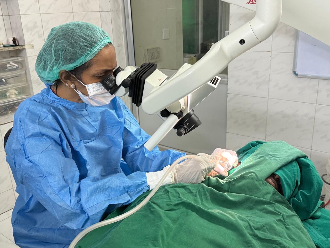 Surgeon using a microscope for a delicate ear surgery in our advanced ENT hospital.